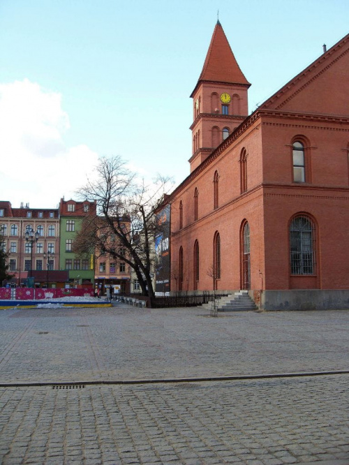 Rynek Nowomiejski o wymiarach 95 x 95 m jest skromniejszy od Rynku Staromiejskiego , znajduje się tutaj Zbór Ewangielicki . #Toruń